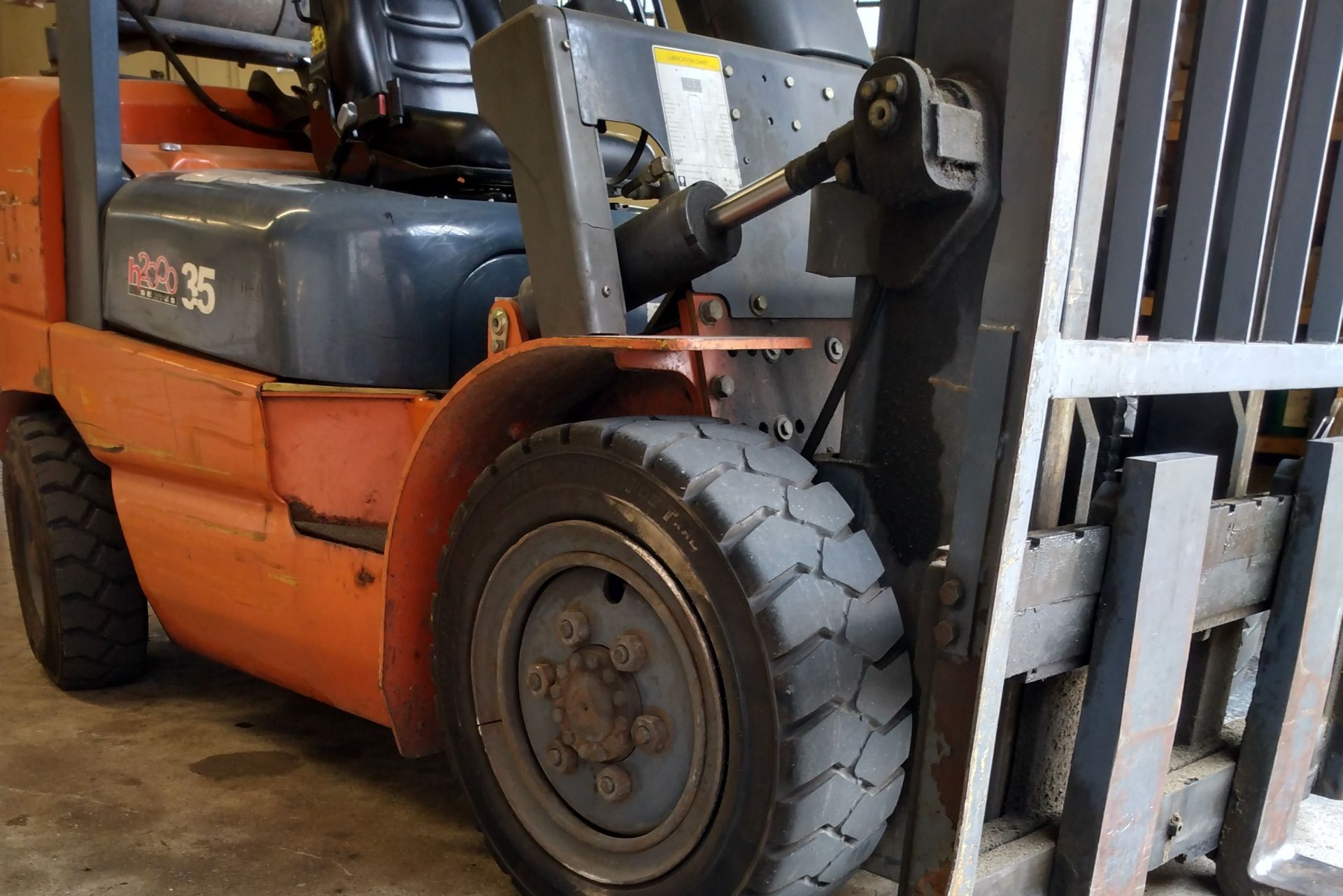 An orange forklift on a job site.