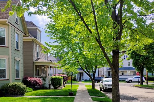 Three young professionals collaborating at a desk in an office setting.