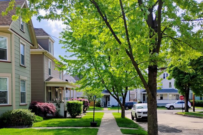 Three young professionals collaborating at a desk in an office setting.